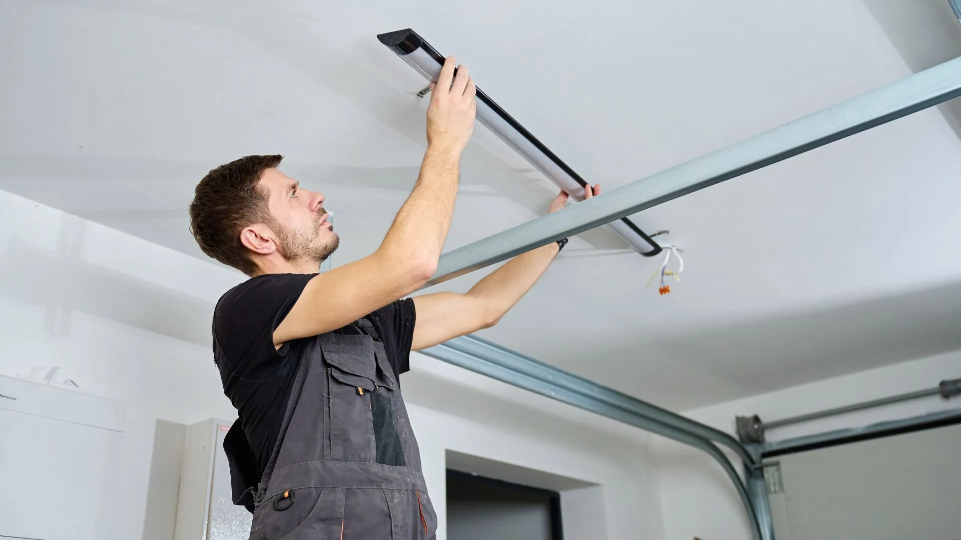 AAA technician installing a garage door rail